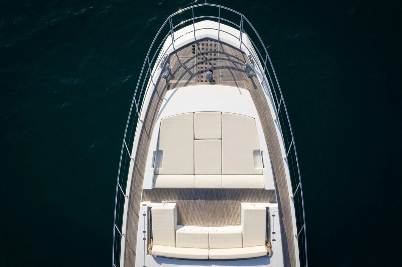 The bow of the yacht features a spacious sunbathing area with plush cushions, perfect for relaxation. aboard TRINIDAD Yacht for Sale