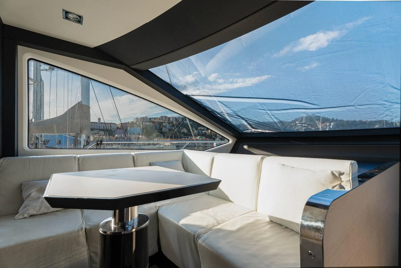 The salon features a comfortable seating area with large windows offering scenic views. aboard TRINIDAD Yacht for Sale