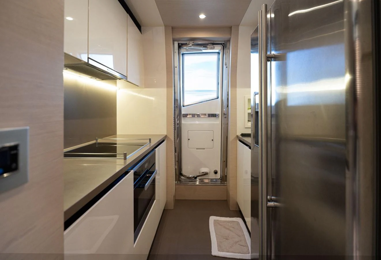 The yacht's galley features modern appliances and sleek cabinetry, offering a functional and stylish space for meal preparation. aboard TRINIDAD Yacht for Sale