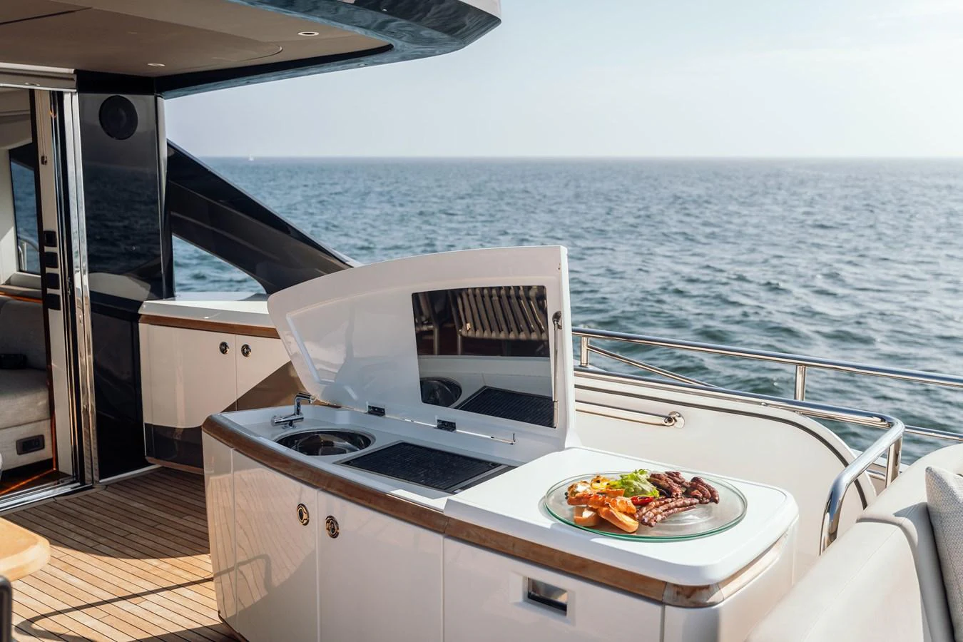 The yacht features an elegant outdoor galley with a scenic ocean view. aboard CHASE Yacht for Sale