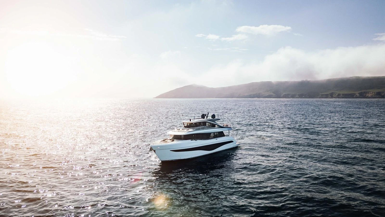 A sleek yacht cruises through calm waters under a bright sky. aboard CHASE Yacht for Sale