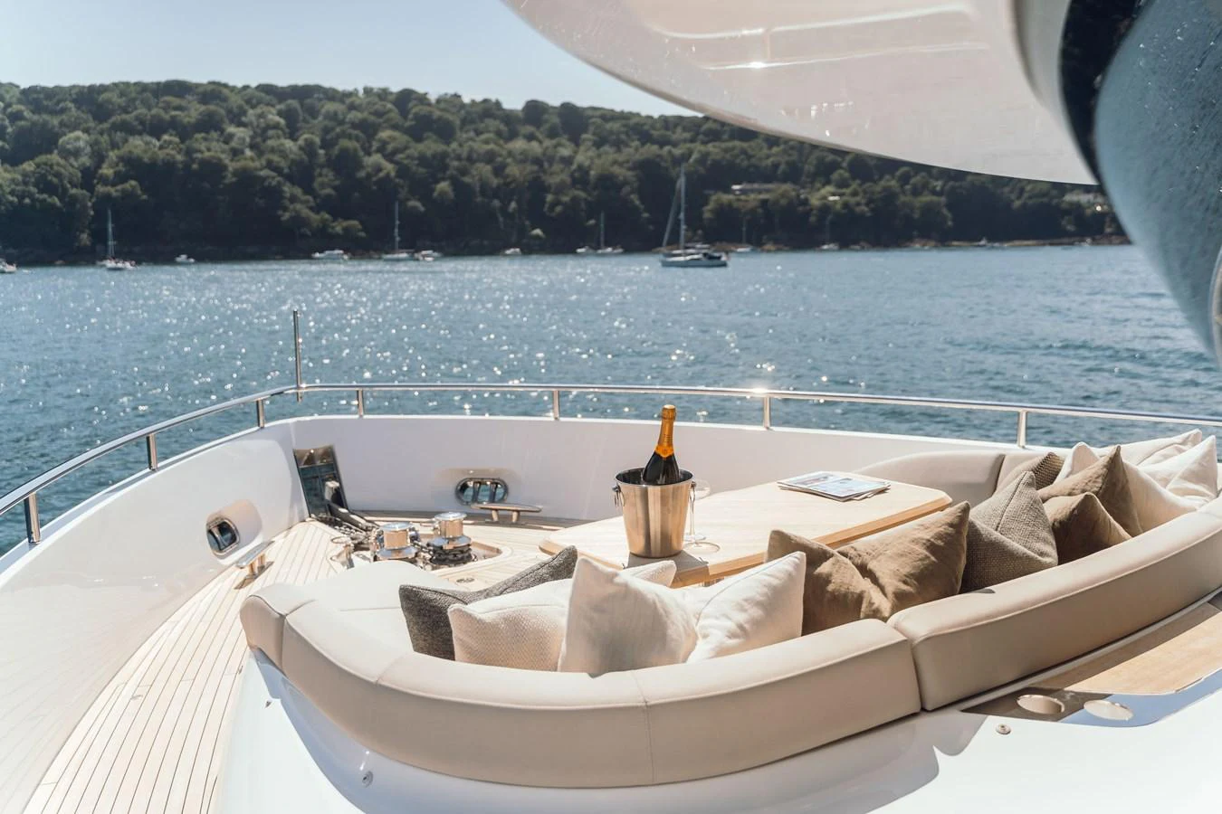 The foredeck offers a luxurious lounging area with plush seating and a champagne bucket, perfect for enjoying the scenic views. aboard CHASE Yacht for Sale
