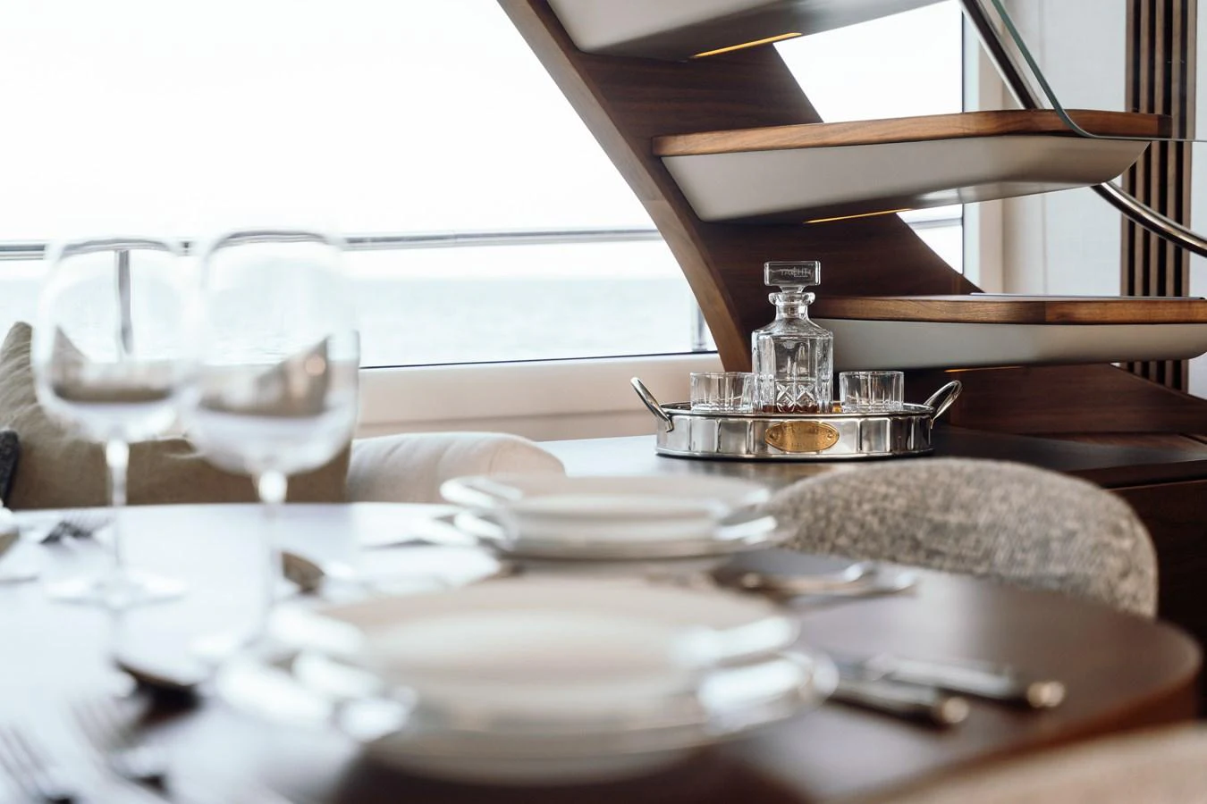 A sophisticated dining area with a view of the sea and elegant table settings. aboard CHASE Yacht for Sale
