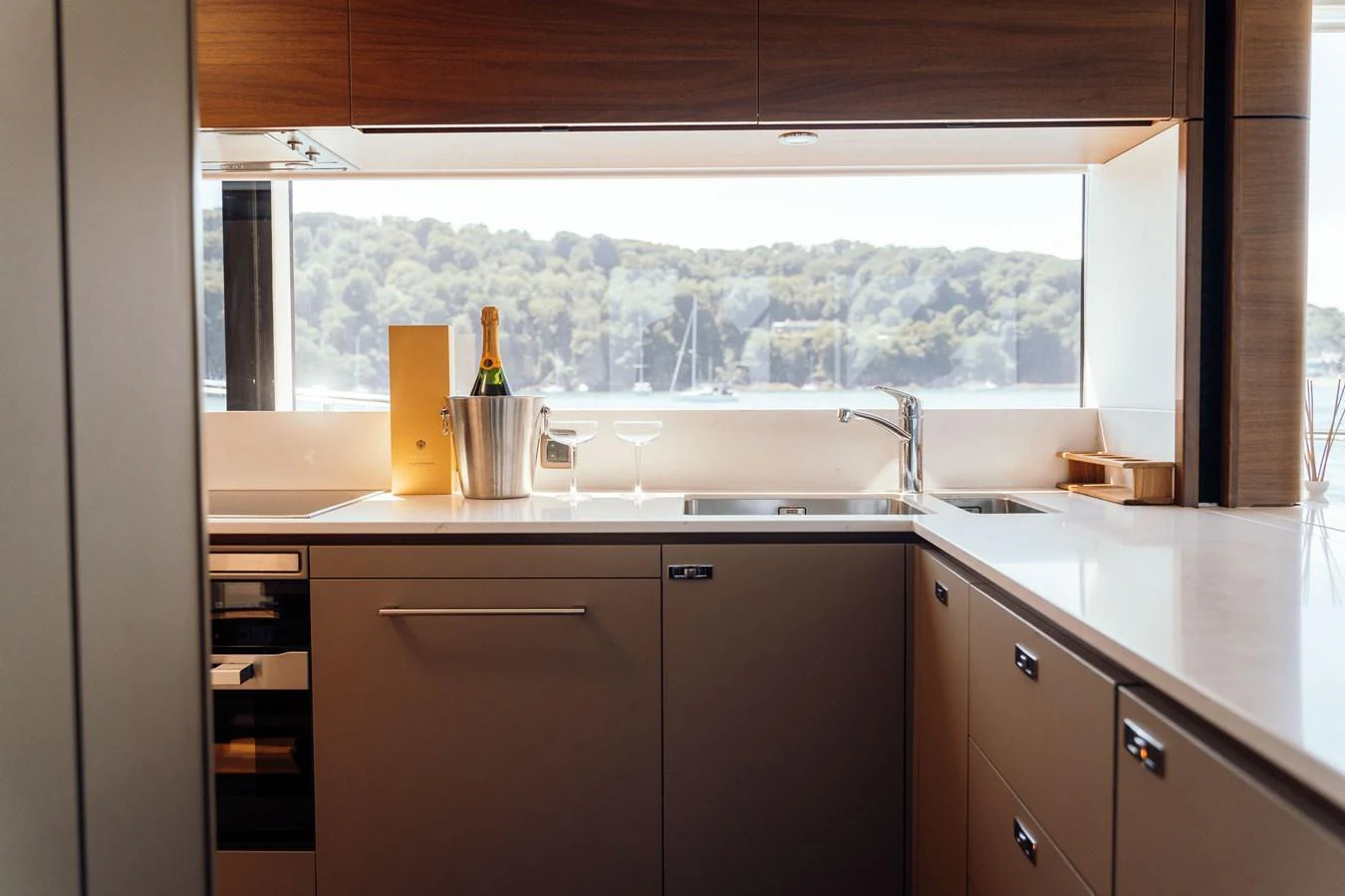 The yacht's galley features modern appliances and a scenic view through a large window. aboard CHASE Yacht for Sale