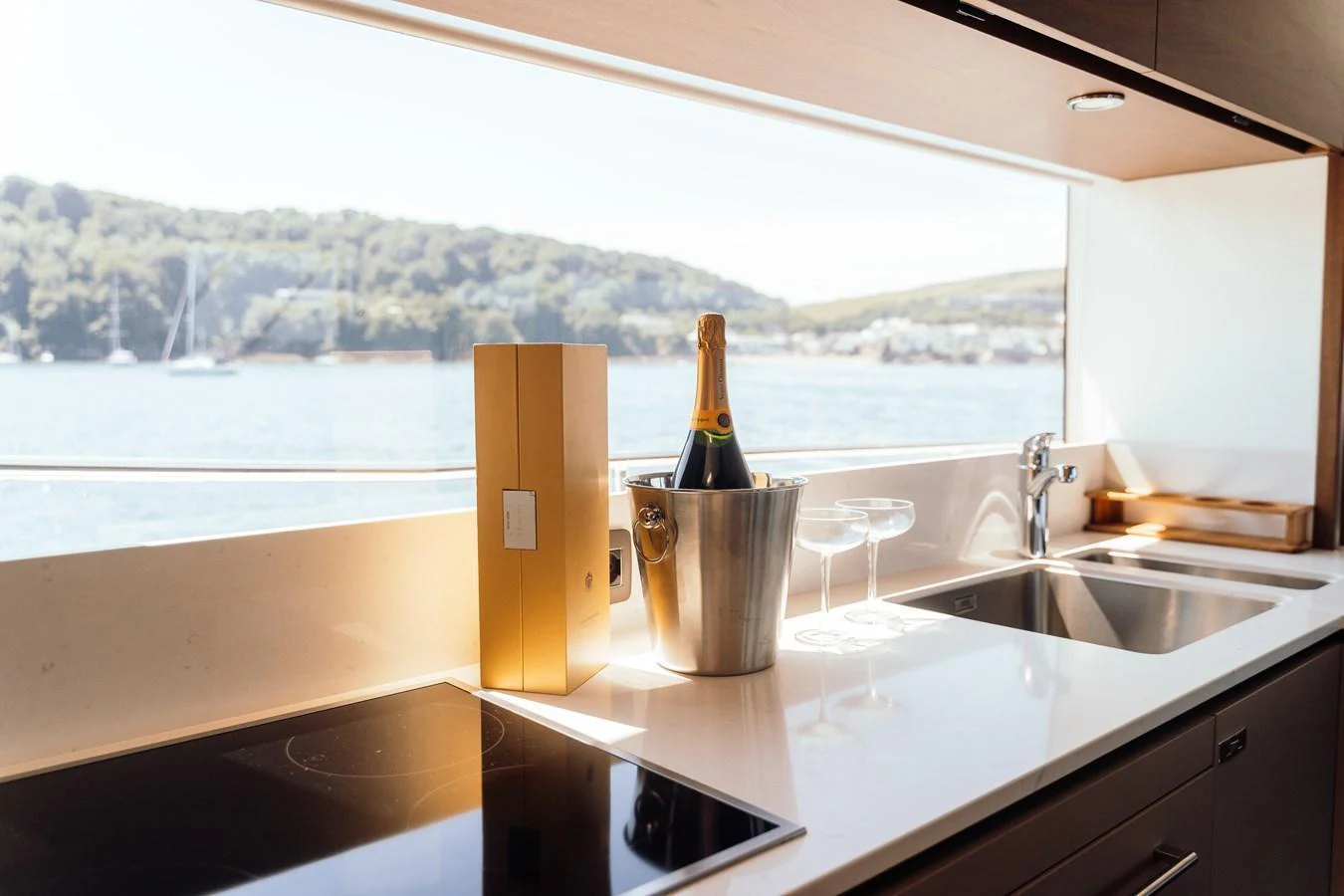 The galley features modern appliances and a scenic view through a large window. aboard CHASE Yacht for Sale