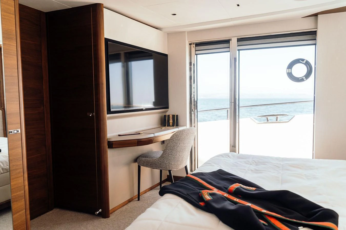 The stateroom features a cozy workspace with a view of the sea through large windows. aboard CHASE Yacht for Sale