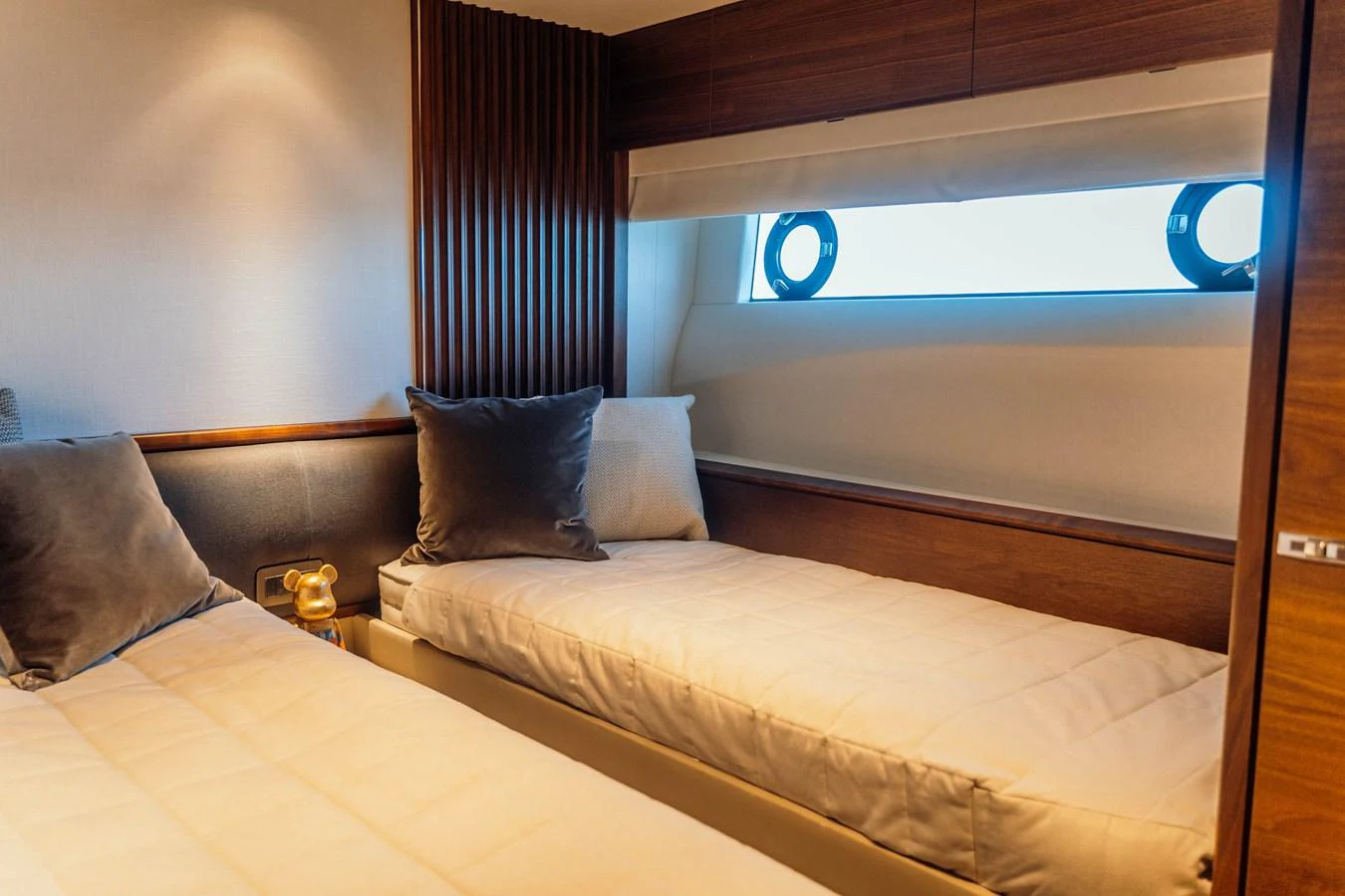 The guest stateroom features twin beds with plush pillows and a sleek, modern design. aboard CHASE Yacht for Sale