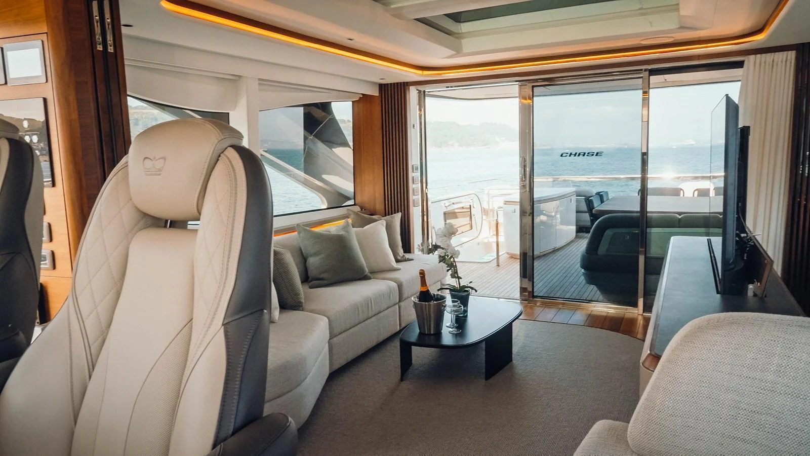 The salon offers a luxurious and comfortable space with panoramic views and elegant furnishings. aboard CHASE Yacht for Sale