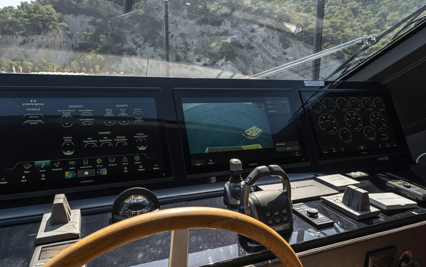 The helm features advanced navigation and control systems with multiple displays and instruments. aboard ORCA I Yacht for Sale