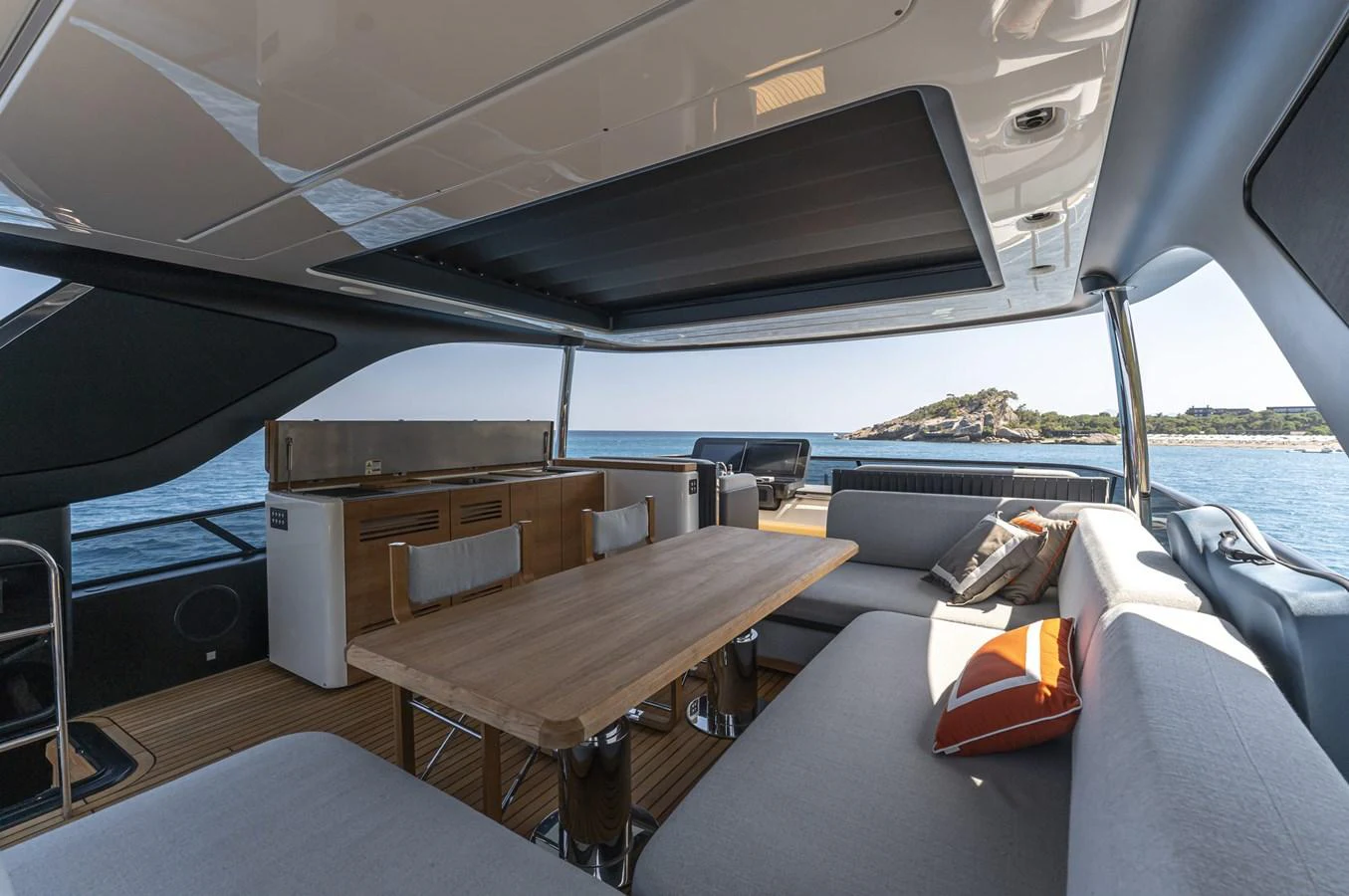 The salon offers a spacious and comfortable seating area with a view of the sea. aboard ORCA I Yacht for Sale