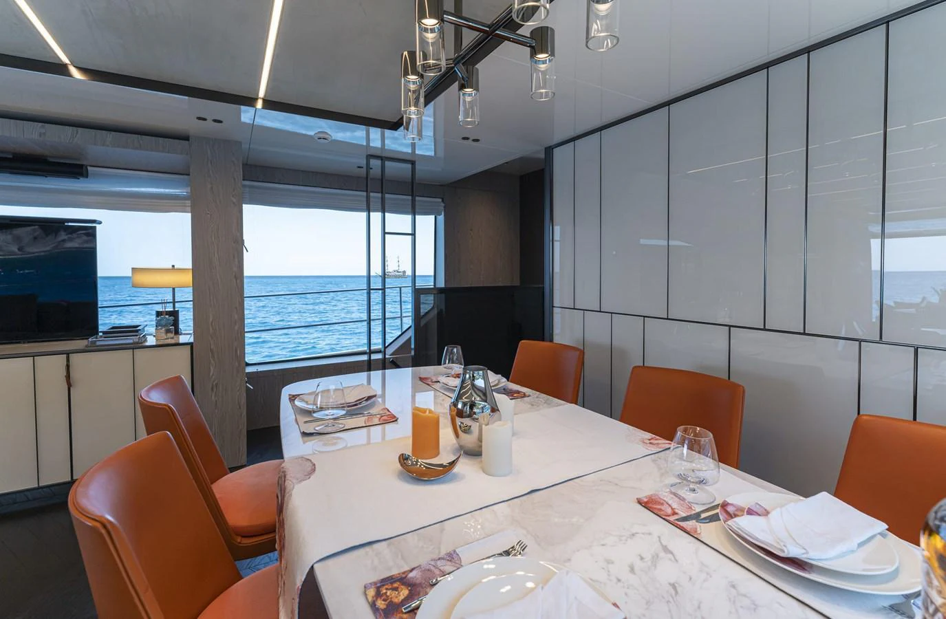 The yacht's dining area offers a sophisticated setting with a view of the sea. aboard ORCA I Yacht for Sale