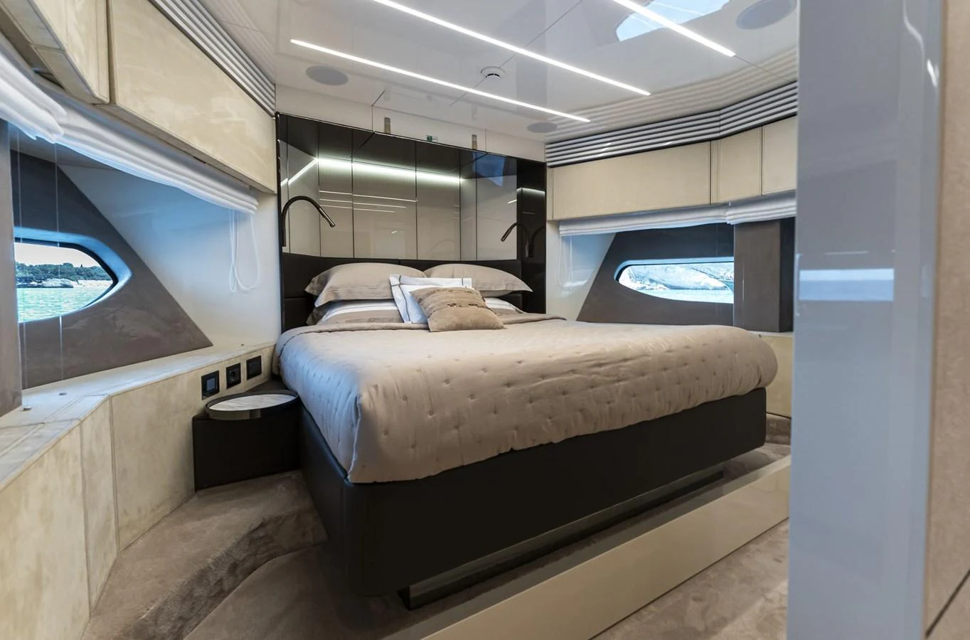 A luxurious stateroom featuring a large bed with elegant bedding and modern design elements. aboard ORCA I Yacht for Sale