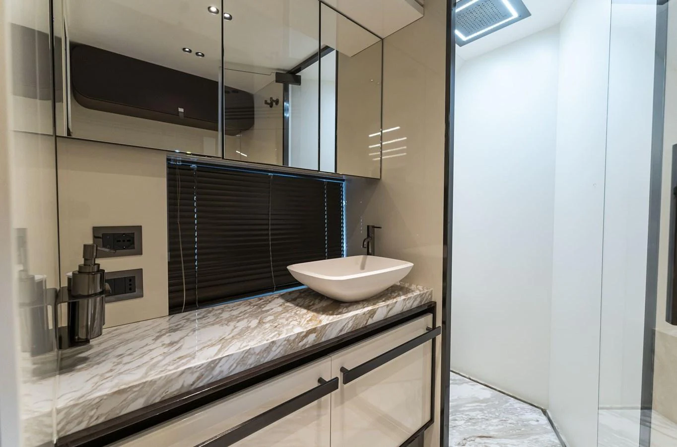 The yacht's bathroom features a sleek design with a modern sink and marble countertop. aboard ORCA I Yacht for Sale