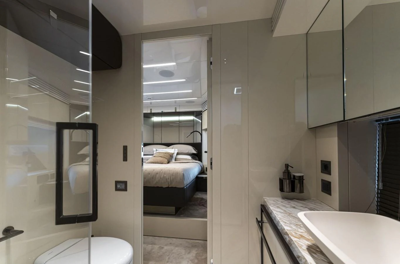 A luxurious stateroom with a plush bed and modern amenities. aboard ORCA I Yacht for Sale