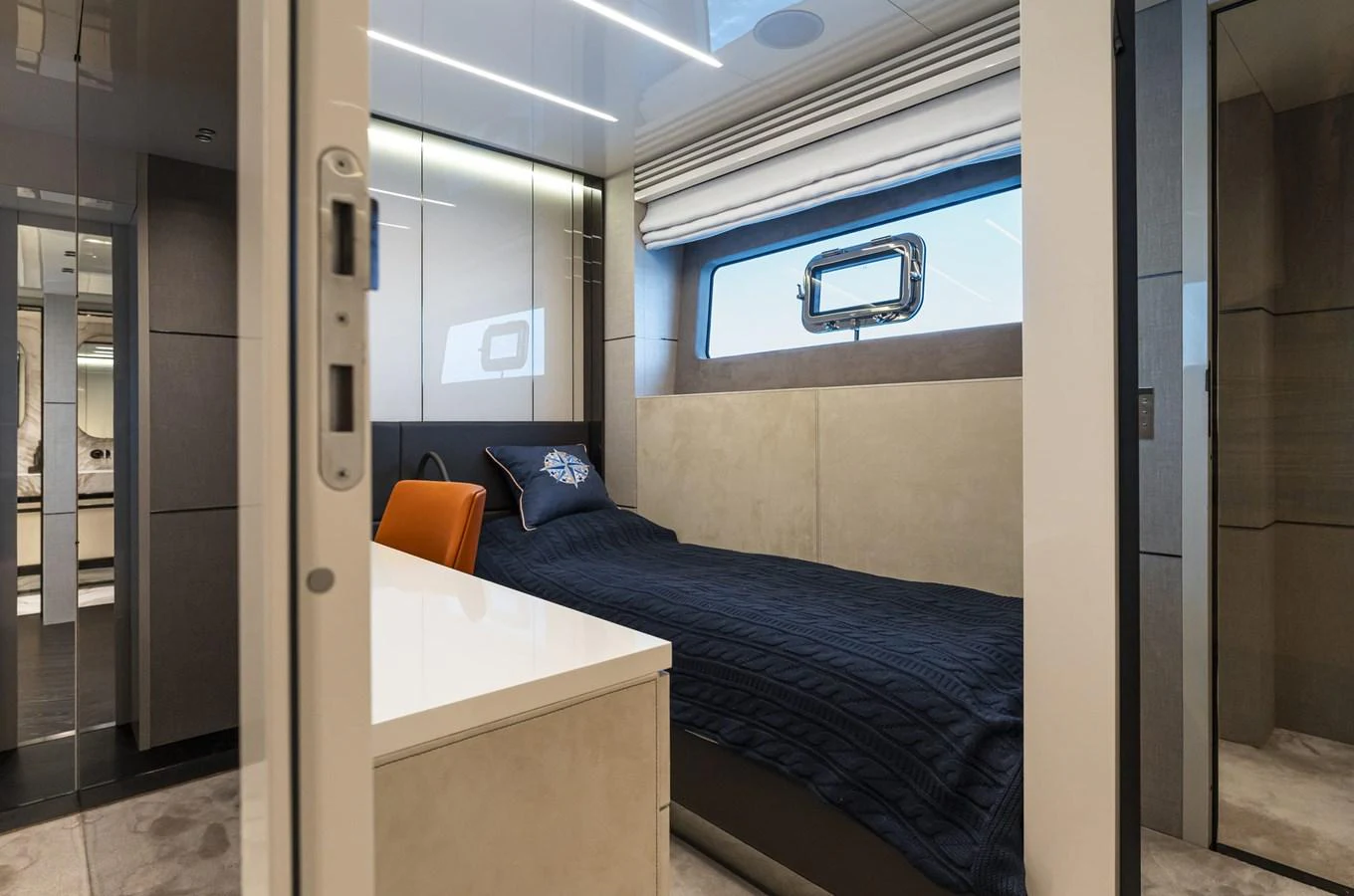 The guest stateroom features a sleek, modern design with a comfortable single bed and ample natural light. aboard ORCA I Yacht for Sale