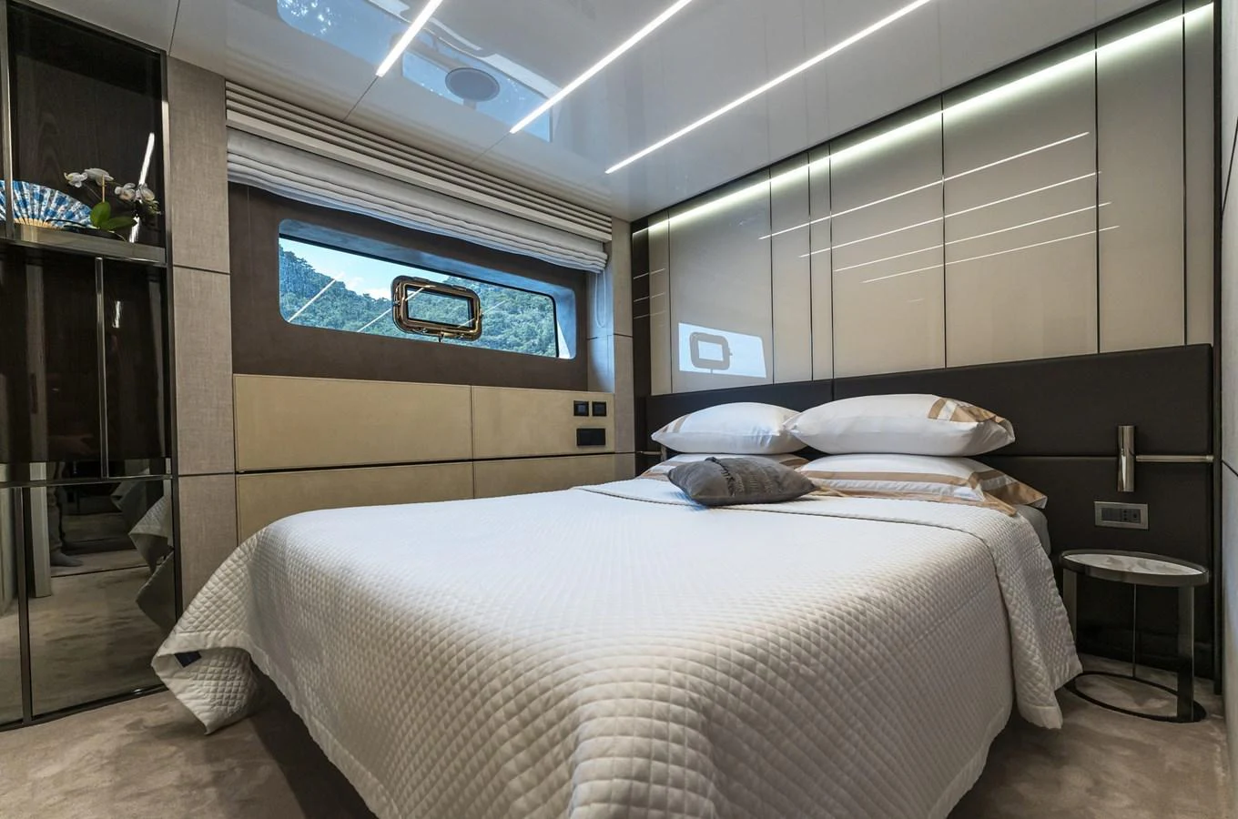 A luxurious stateroom featuring a comfortable bed and modern decor. aboard ORCA I Yacht for Sale