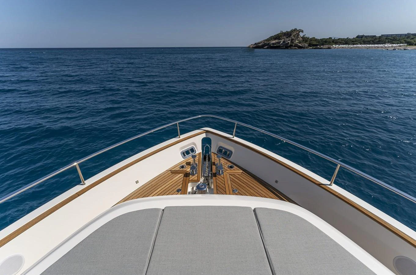 The yacht's bow offers a serene view of the open sea and distant shoreline. aboard ORCA I Yacht for Sale