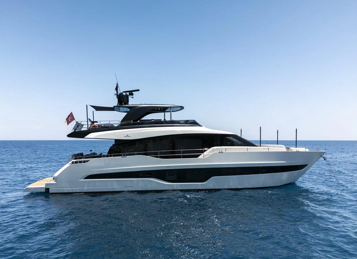 A sleek and modern yacht cruising on calm blue waters under a clear sky. aboard ORCA I Yacht for Sale