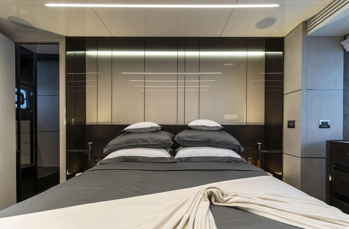 The master stateroom features a luxurious bed with elegant linens and modern decor. aboard ORCA I Yacht for Sale