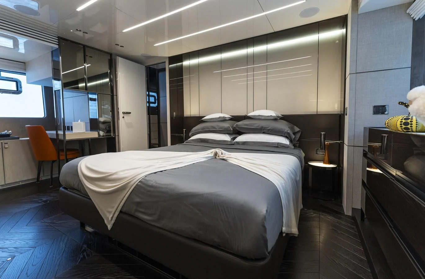 The stateroom features a luxurious bed with modern decor and ample natural light. aboard ORCA I Yacht for Sale
