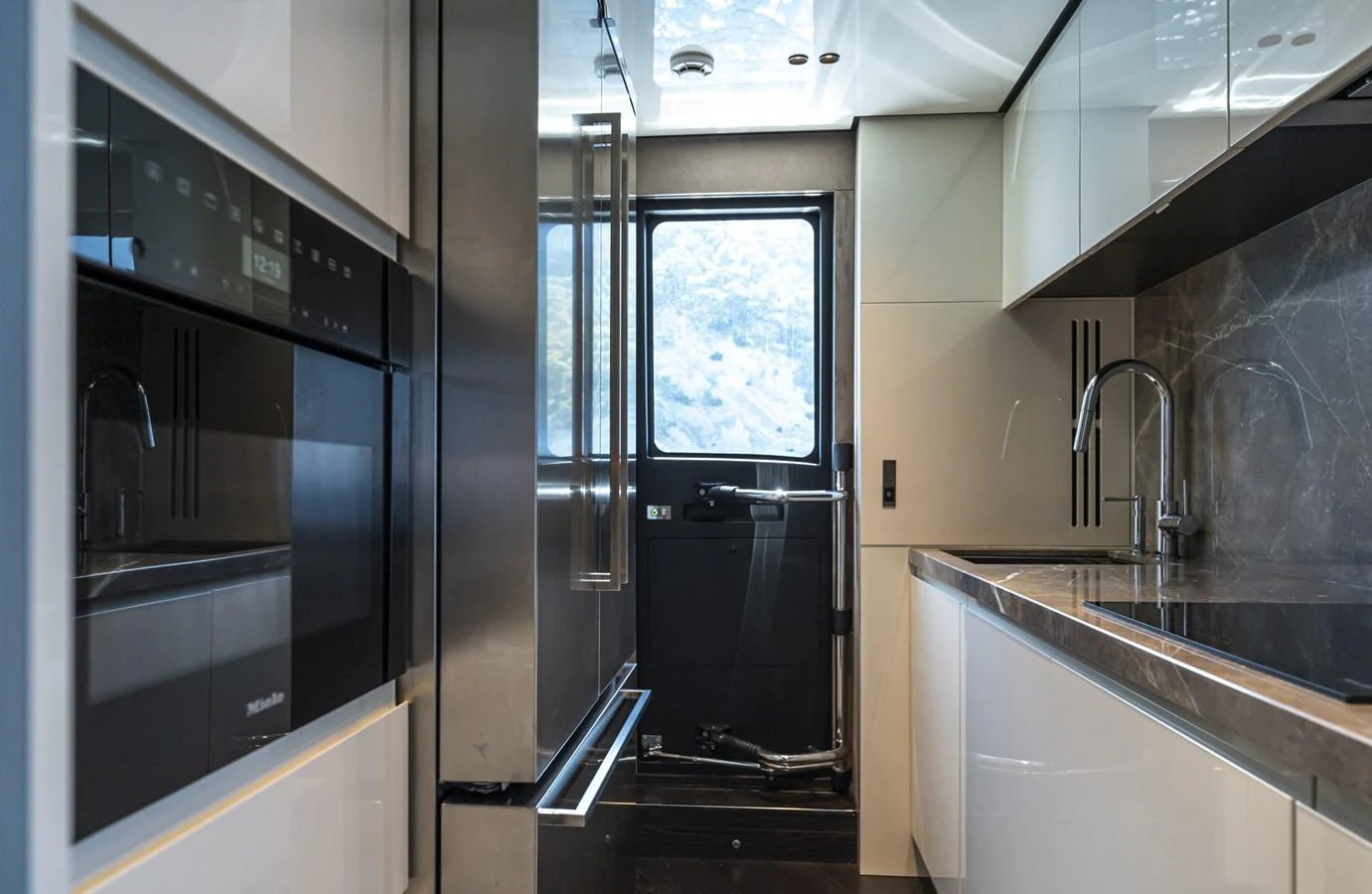 The modern galley features sleek appliances and ample counter space, perfect for gourmet cooking at sea. aboard ORCA I Yacht for Sale