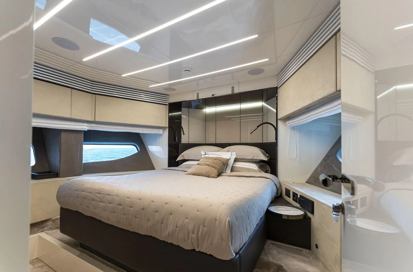 The stateroom features a luxurious bed with modern decor and ample natural light. aboard ORCA I Yacht for Sale