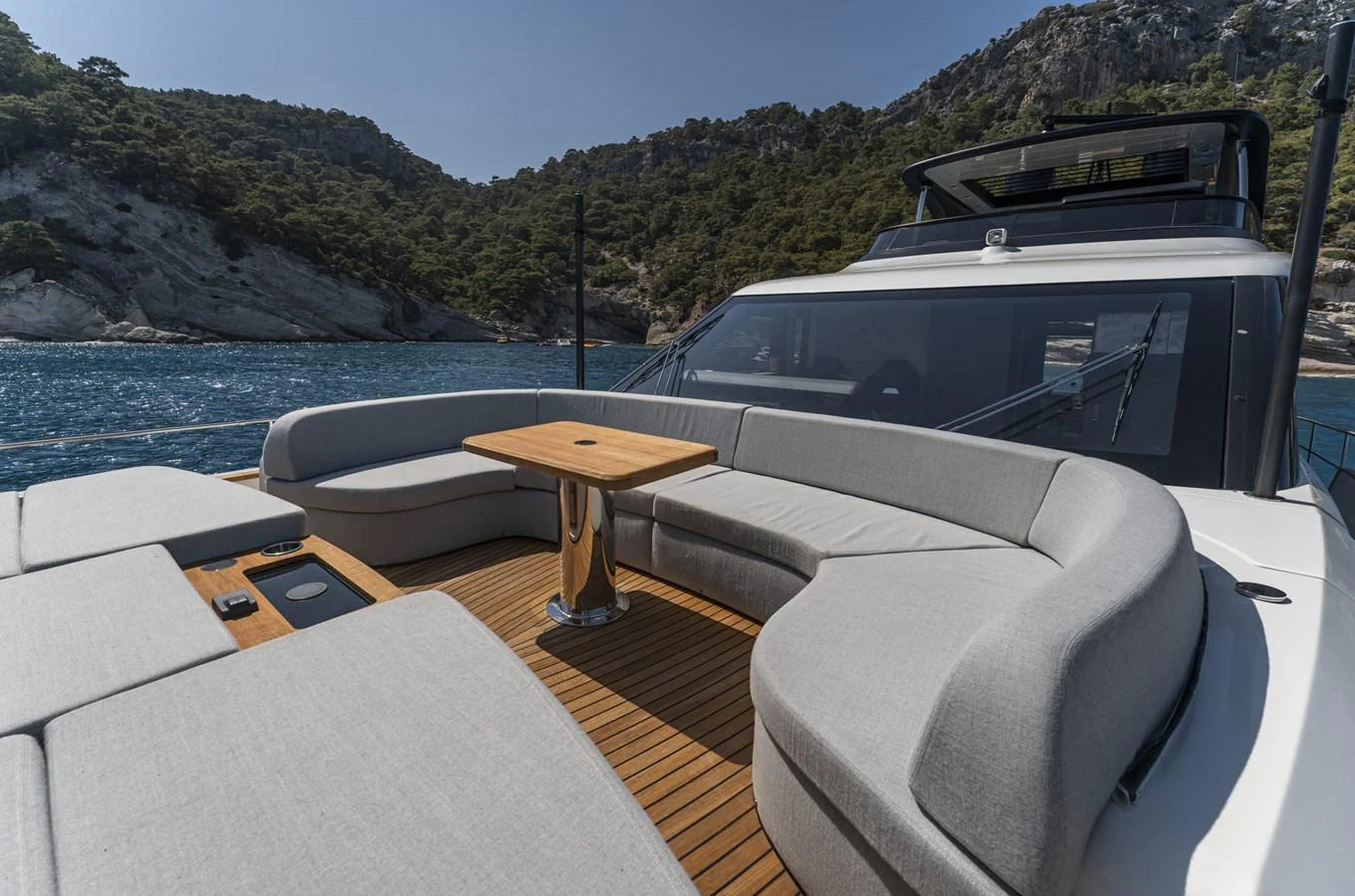 The flybridge offers a spacious seating area with a central table, perfect for enjoying the scenic views. aboard ORCA I Yacht for Sale