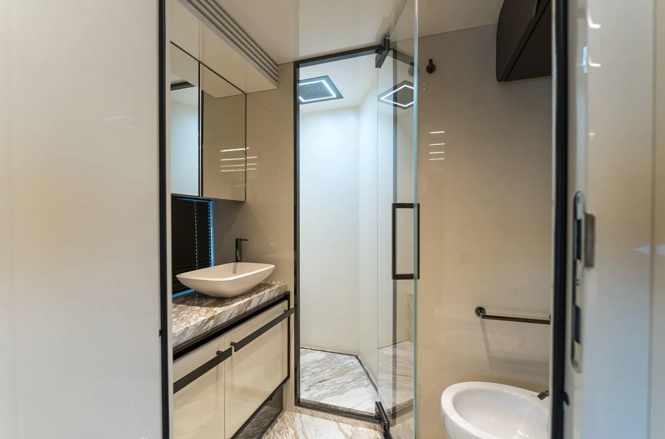 A sleek and modern yacht bathroom featuring a glass-enclosed shower and elegant fixtures. aboard ORCA I Yacht for Sale