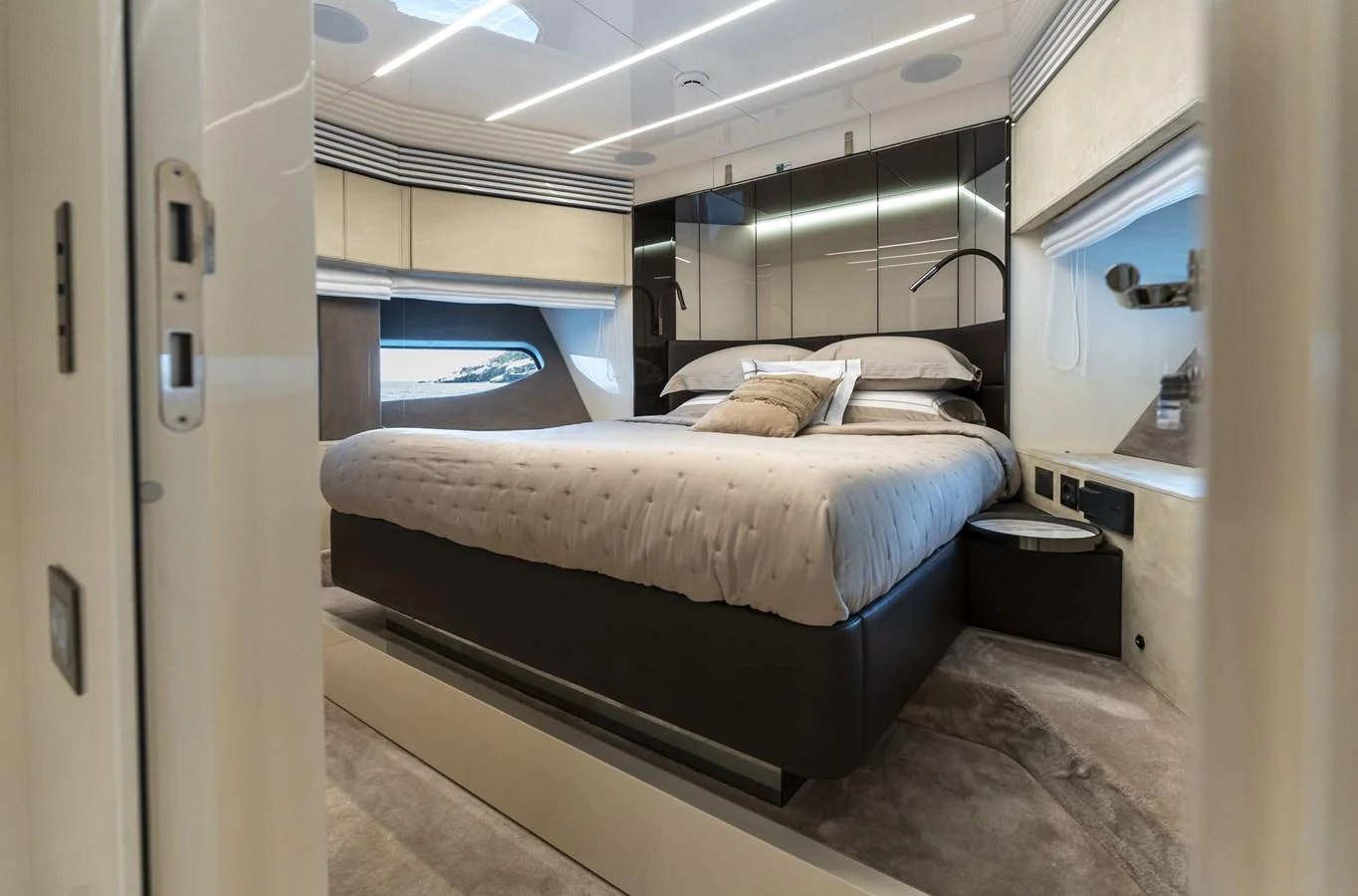 The stateroom features a luxurious bed with modern decor and ample natural light. aboard ORCA I Yacht for Sale