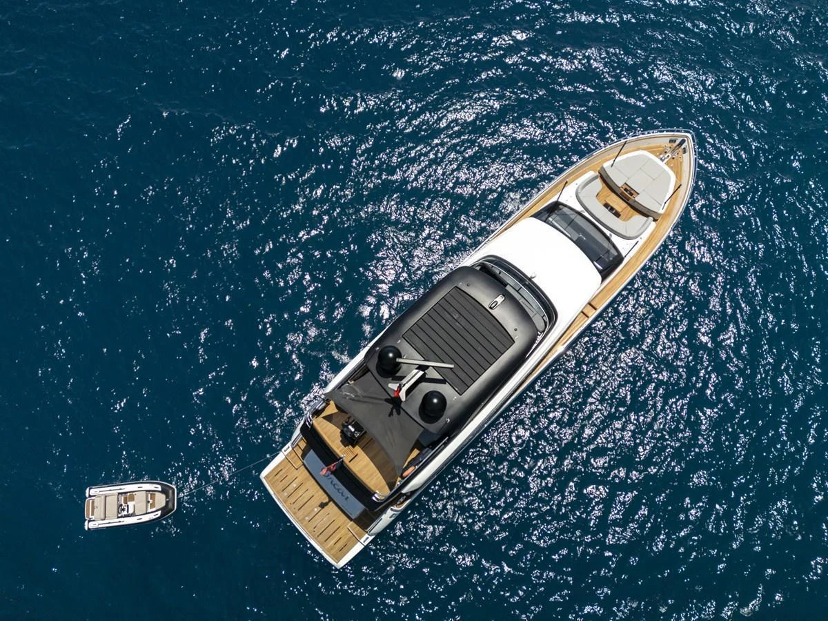 Aerial view of a sleek yacht cruising on the open sea, accompanied by a small tender. aboard ORCA I Yacht for Sale