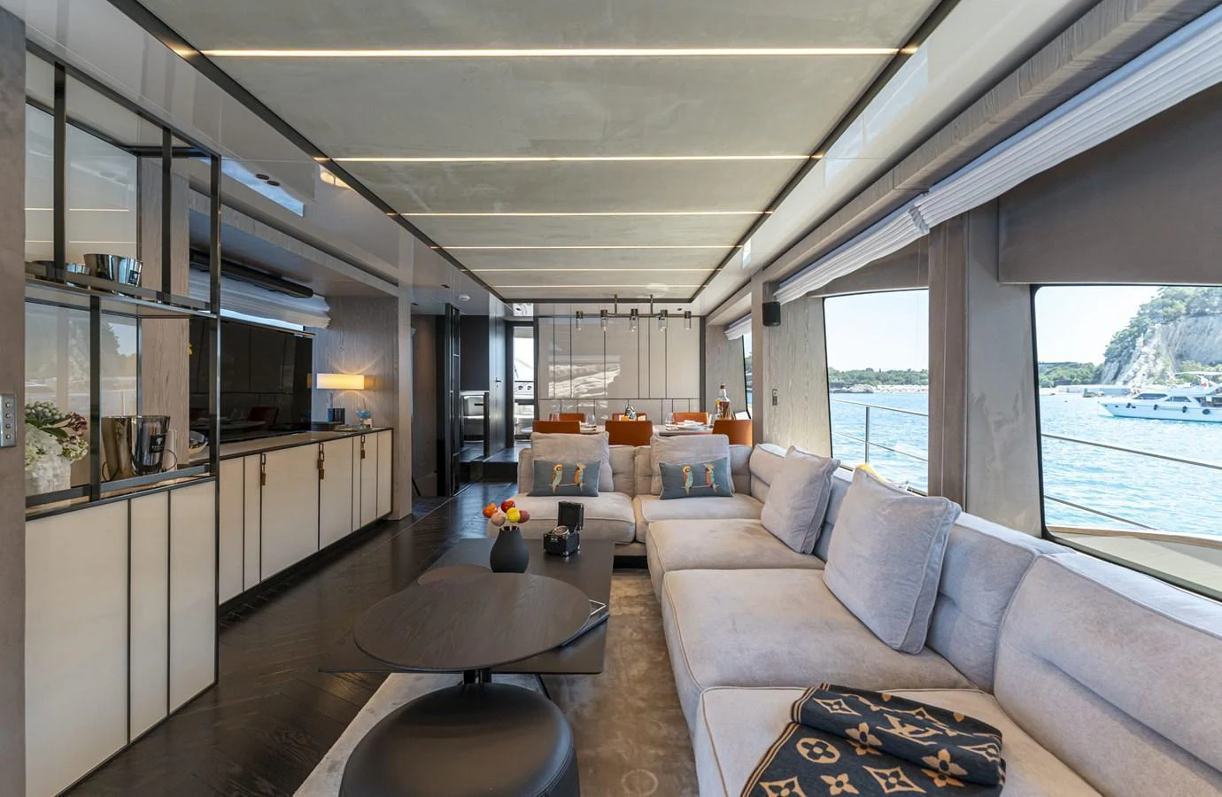 The spacious salon features modern furnishings and large windows offering stunning views. aboard ORCA I Yacht for Sale