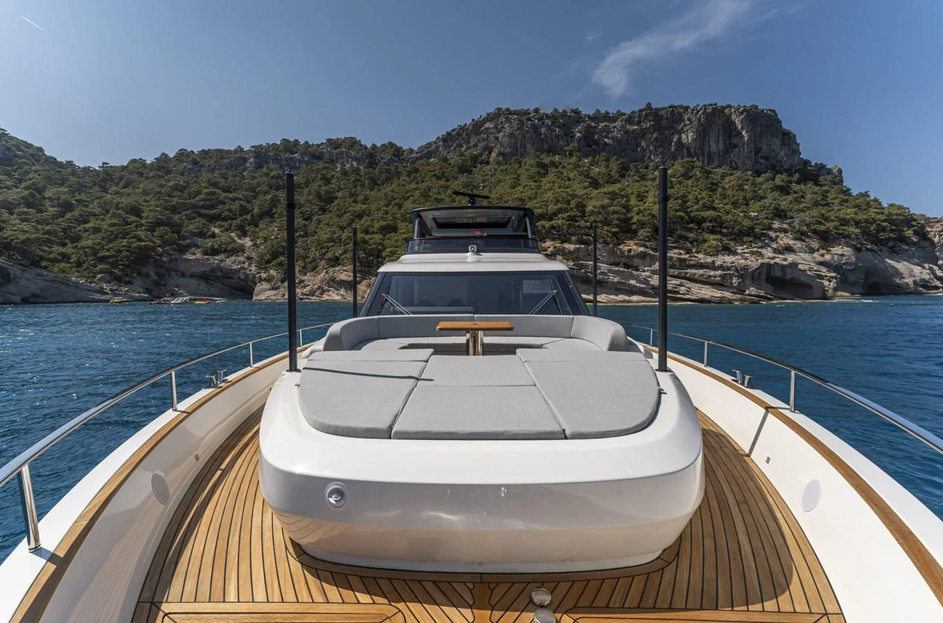 The foredeck features a spacious sunpad with stunning views of the surrounding waters and cliffs. aboard ORCA I Yacht for Sale