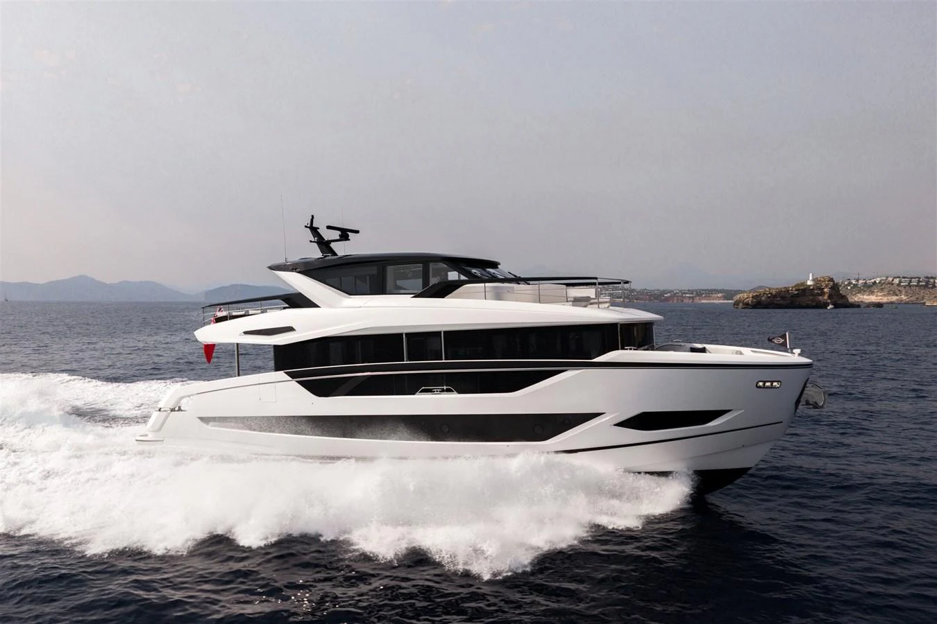 A sleek and modern yacht glides effortlessly through the open water, showcasing its elegant design and powerful performance. aboard 82 OCEAN ENCLOSED Yacht for Sale
