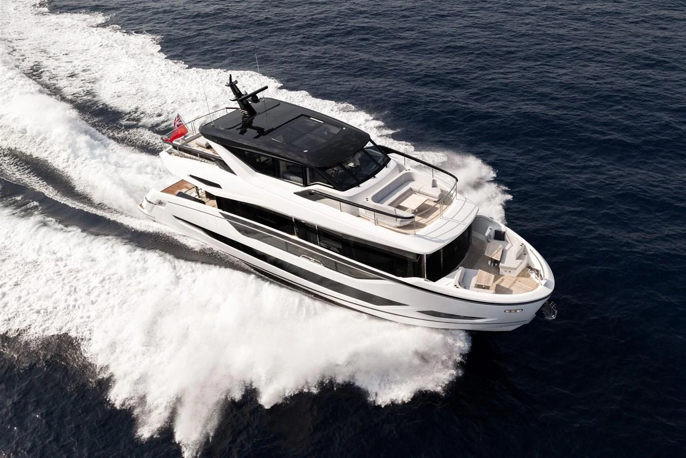 A sleek and modern yacht cruises swiftly through the open water, showcasing its elegant design and luxurious amenities. aboard 82 OCEAN ENCLOSED Yacht for Sale