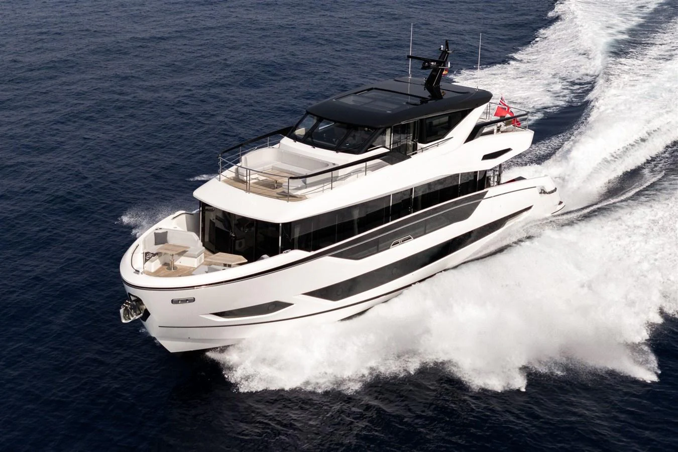 A sleek and modern yacht cruises swiftly through the open water, showcasing its elegant design and powerful performance. aboard 82 OCEAN ENCLOSED Yacht for Sale