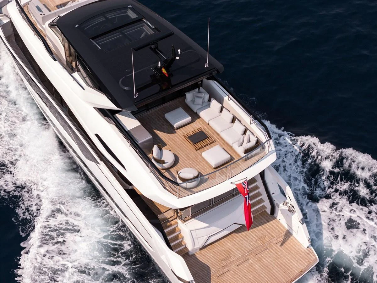 The yacht's aft deck features luxurious seating and lounging areas, perfect for relaxation while cruising. aboard 82 OCEAN ENCLOSED Yacht for Sale