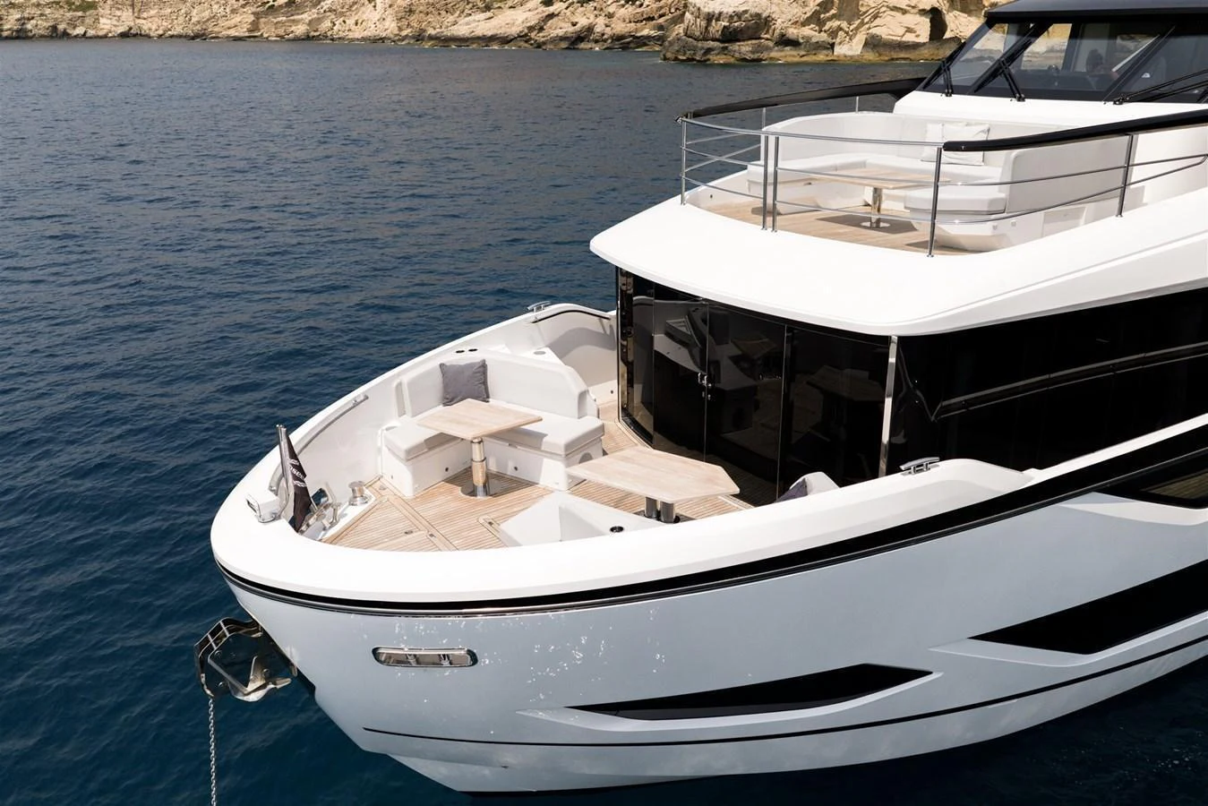 The yacht's aft deck offers a spacious and inviting area for relaxation and dining, with stunning views of the surrounding waters. aboard 82 OCEAN ENCLOSED Yacht for Sale