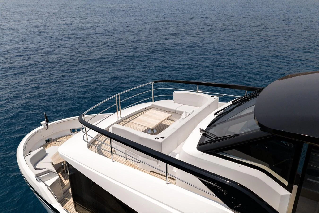 The yacht's flybridge offers a spacious and elegant area for relaxation with stunning ocean views. aboard 82 OCEAN ENCLOSED Yacht for Sale