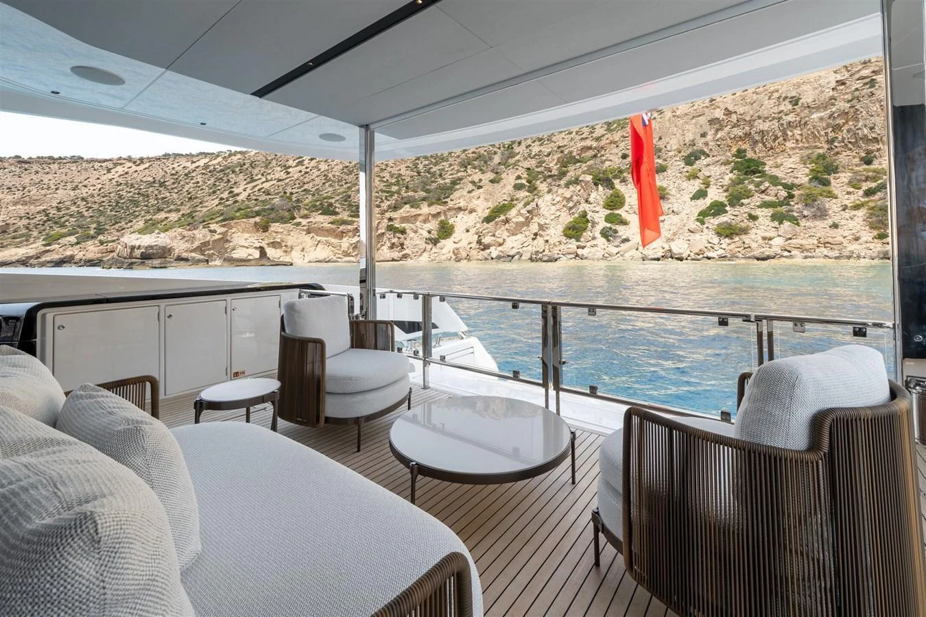 The aft deck offers a serene space with comfortable seating and a stunning view of the surrounding waters. aboard 82 OCEAN ENCLOSED Yacht for Sale