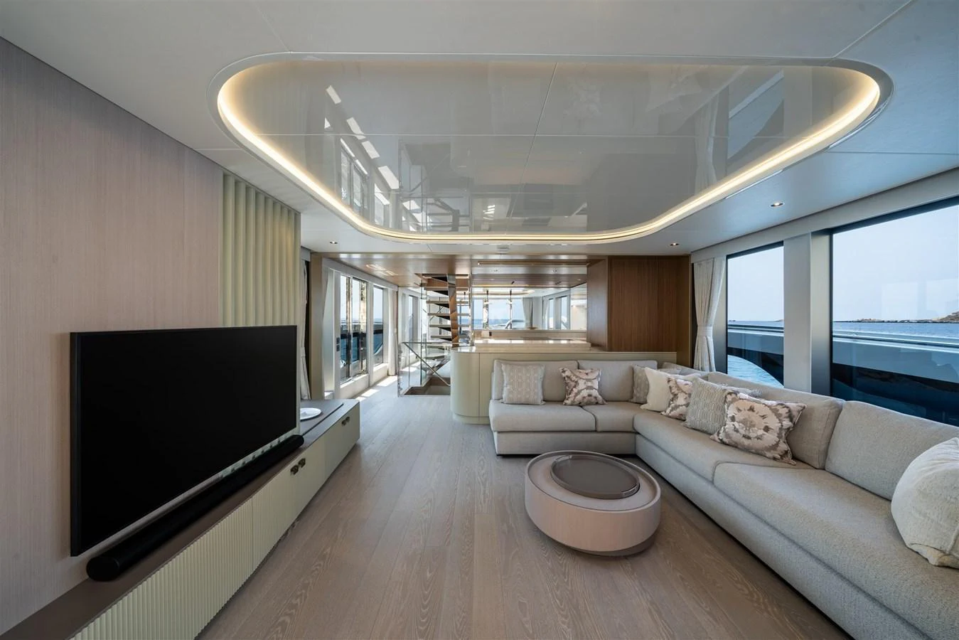 The spacious salon features modern furnishings and large windows for panoramic views. aboard 82 OCEAN ENCLOSED Yacht for Sale