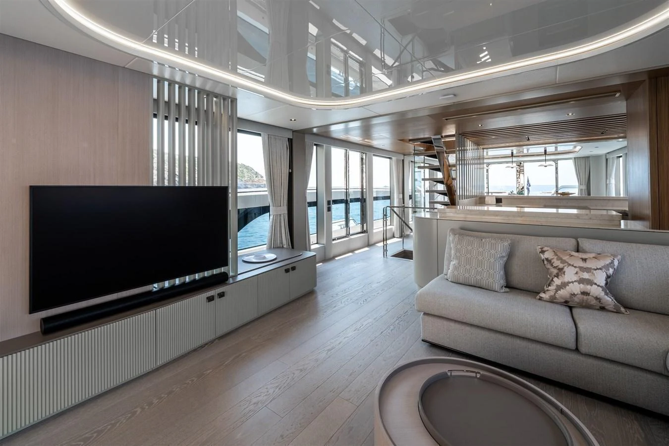 The yacht's salon features a modern and spacious design with ample natural light and elegant furnishings. aboard 82 OCEAN ENCLOSED Yacht for Sale