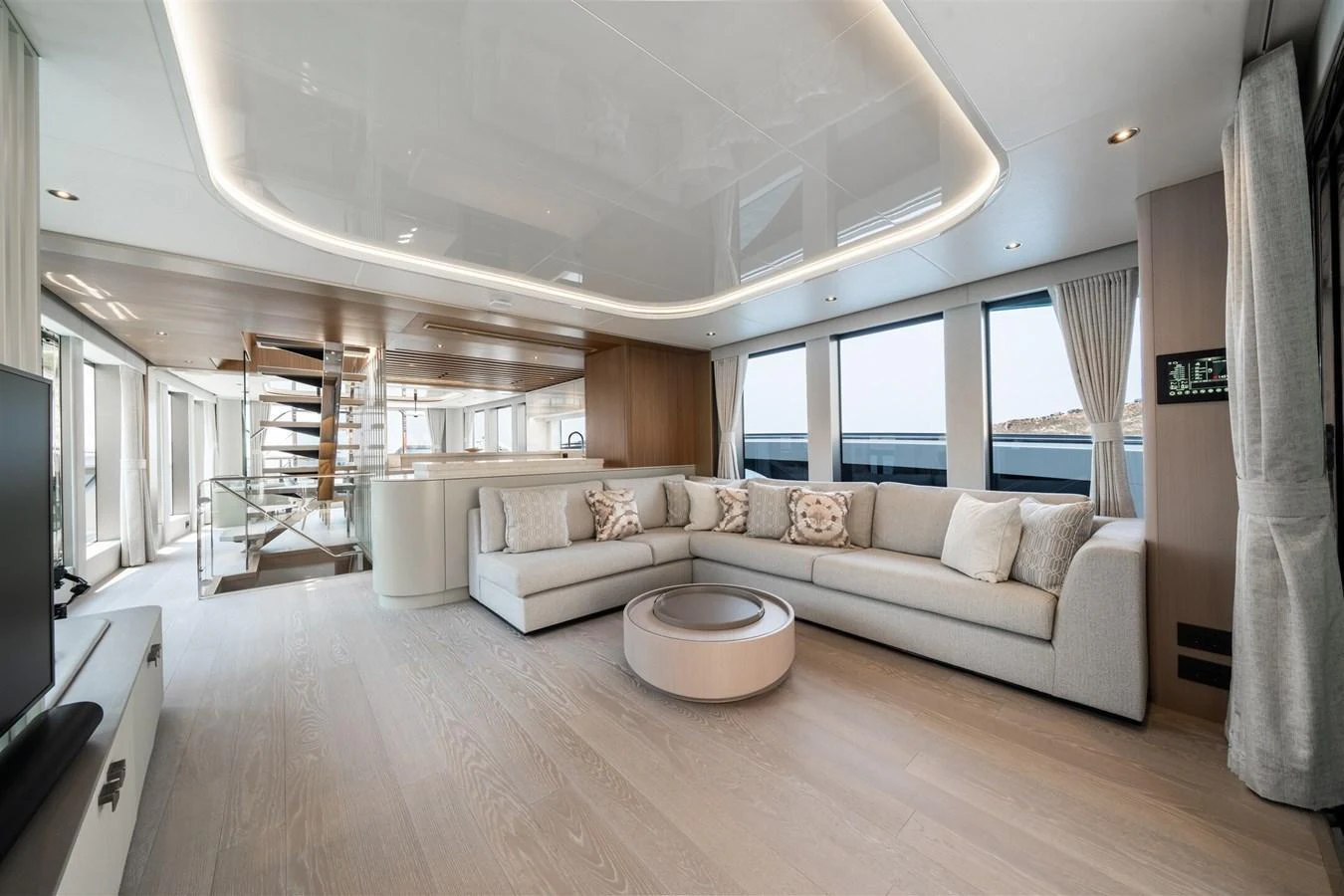 The yacht's salon features a spacious and elegantly designed seating area with modern furnishings and ample natural light. aboard 82 OCEAN ENCLOSED Yacht for Sale