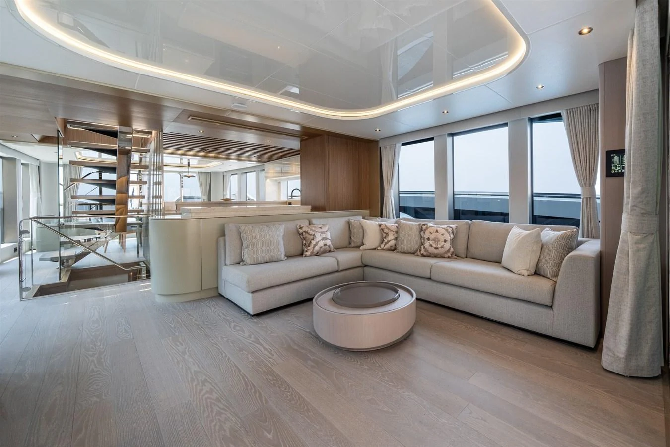 The salon features a spacious and elegant seating area with modern decor and ample natural light. aboard 82 OCEAN ENCLOSED Yacht for Sale
