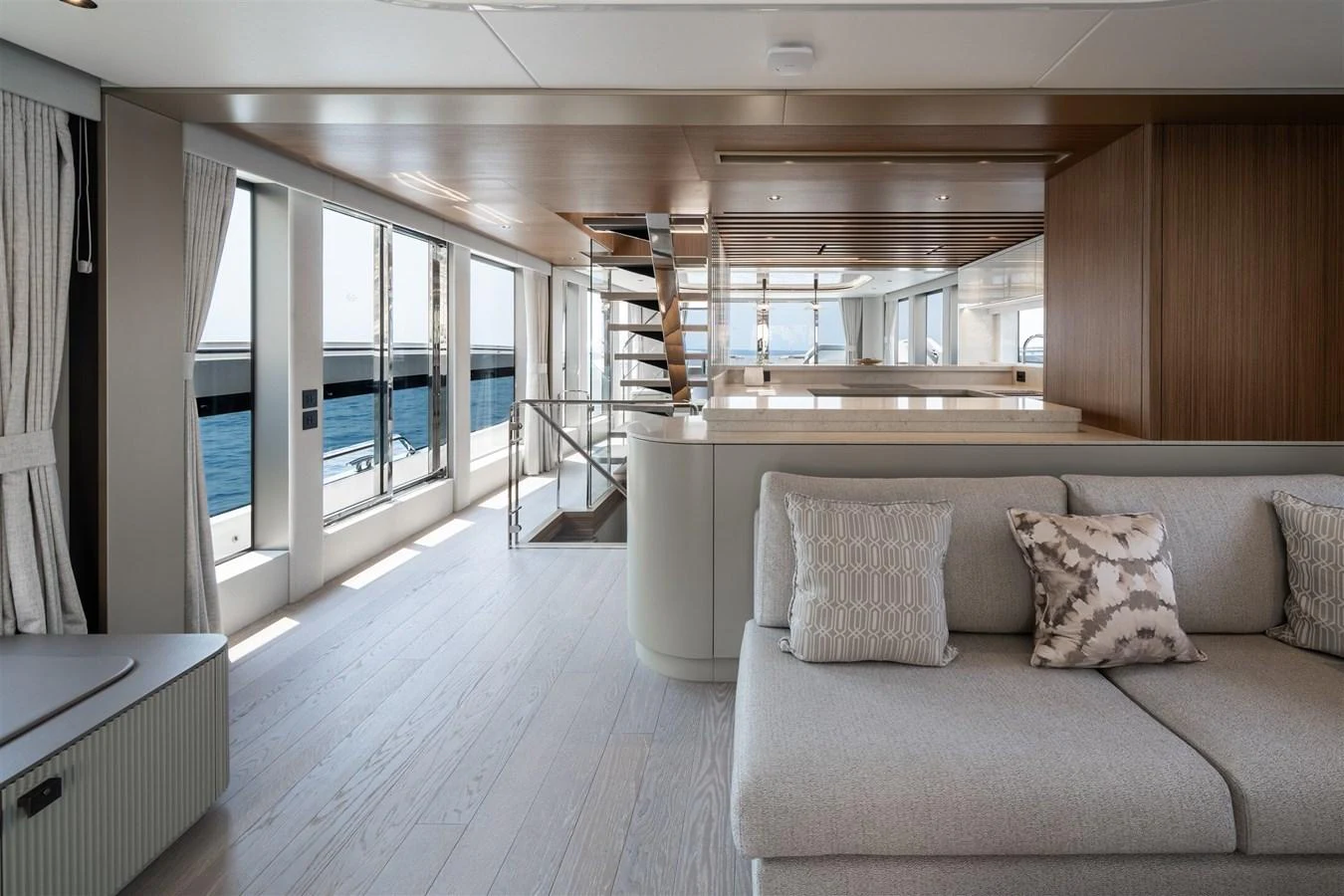 The yacht's interior features a spacious and modern living area with ample natural light and elegant furnishings. aboard 82 OCEAN ENCLOSED Yacht for Sale