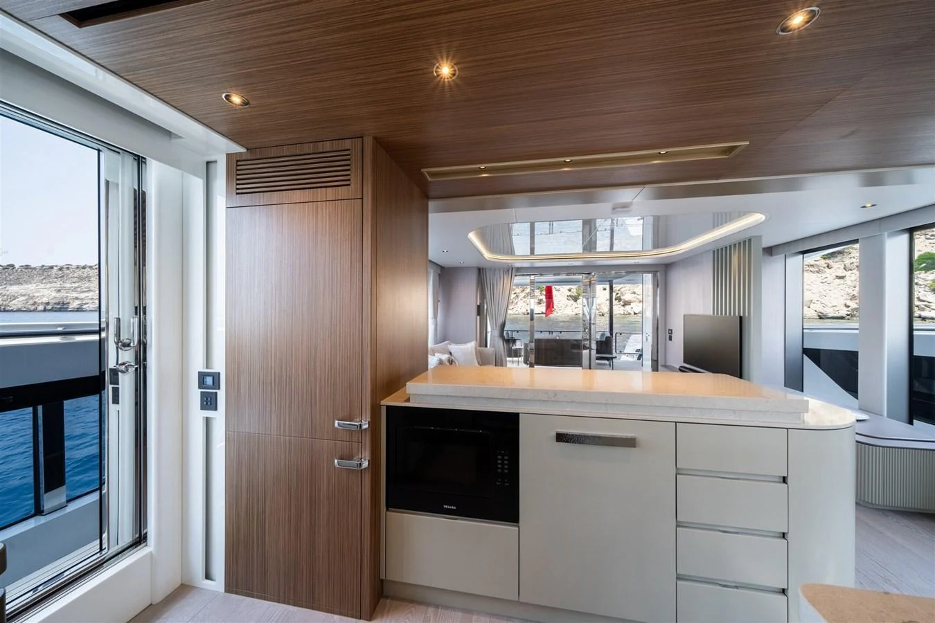 The galley features modern appliances and a sleek design with ample natural light. aboard 82 OCEAN ENCLOSED Yacht for Sale