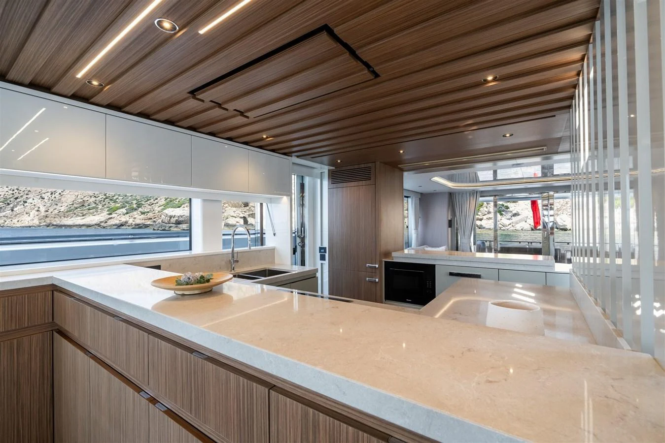 The yacht's galley features modern design with ample counter space and natural light. aboard 82 OCEAN ENCLOSED Yacht for Sale