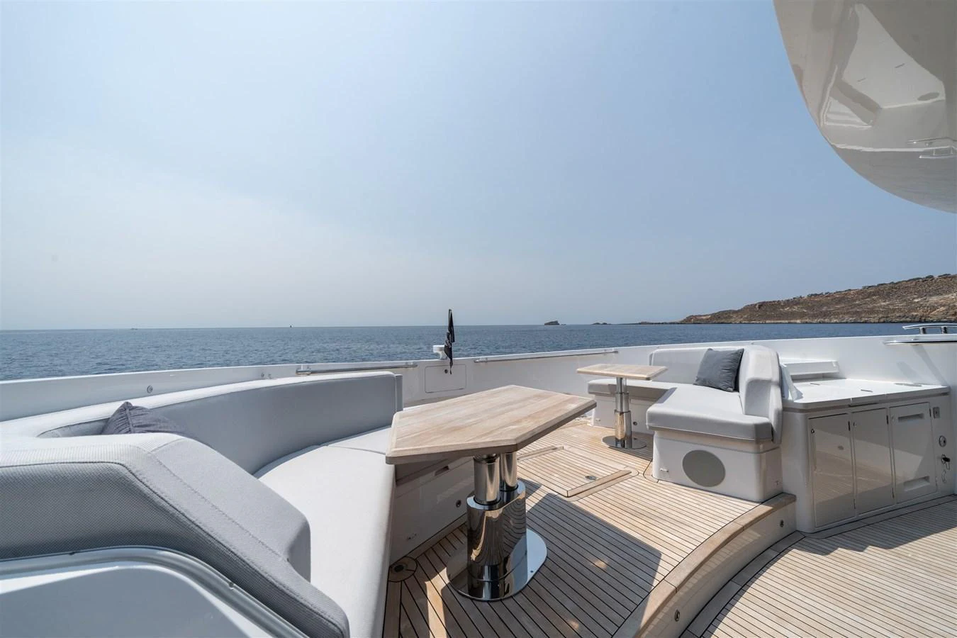 The aft deck offers a spacious and comfortable seating area with stunning ocean views. aboard 82 OCEAN ENCLOSED Yacht for Sale