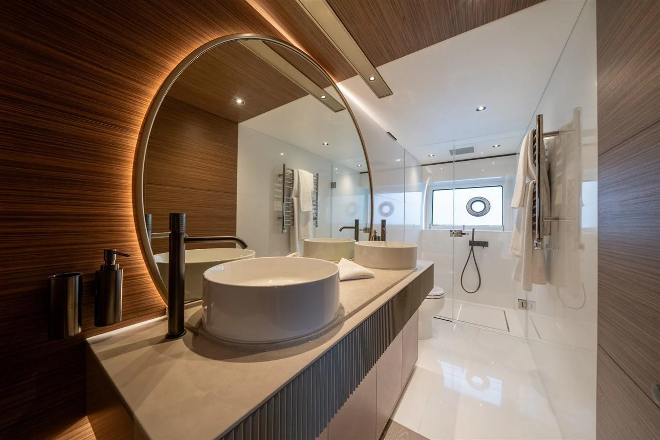 A luxurious yacht bathroom featuring modern fixtures and elegant design. aboard 82 OCEAN ENCLOSED Yacht for Sale