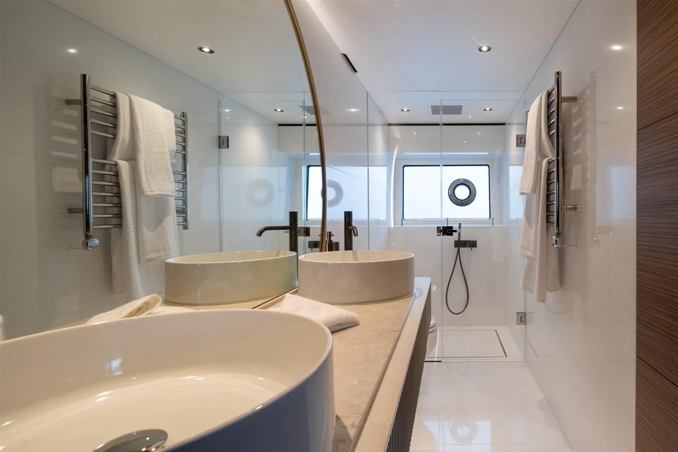 The bathroom features modern fixtures and a sleek design with a spacious shower area. aboard 82 OCEAN ENCLOSED Yacht for Sale