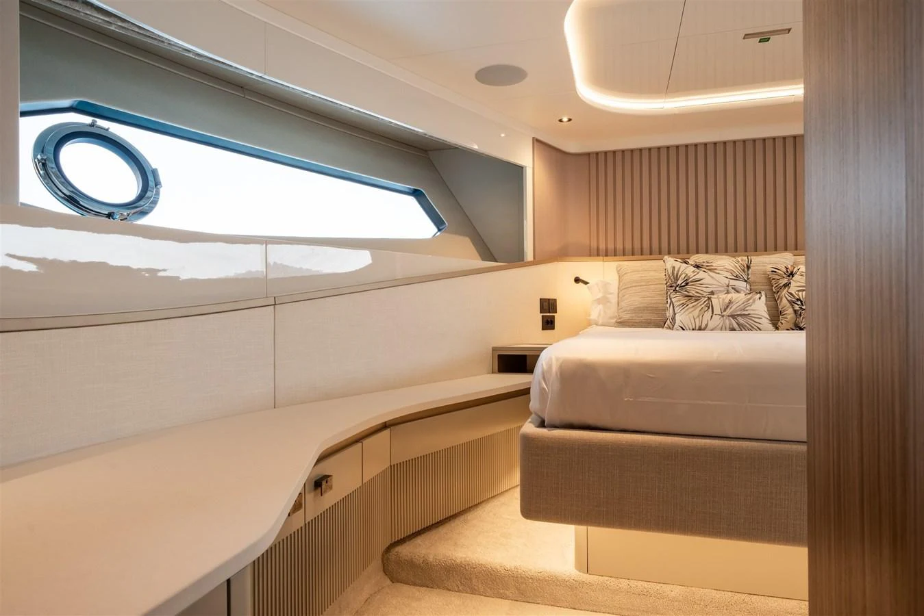 A luxurious stateroom featuring a large bed, modern decor, and ample natural light. aboard 82 OCEAN ENCLOSED Yacht for Sale